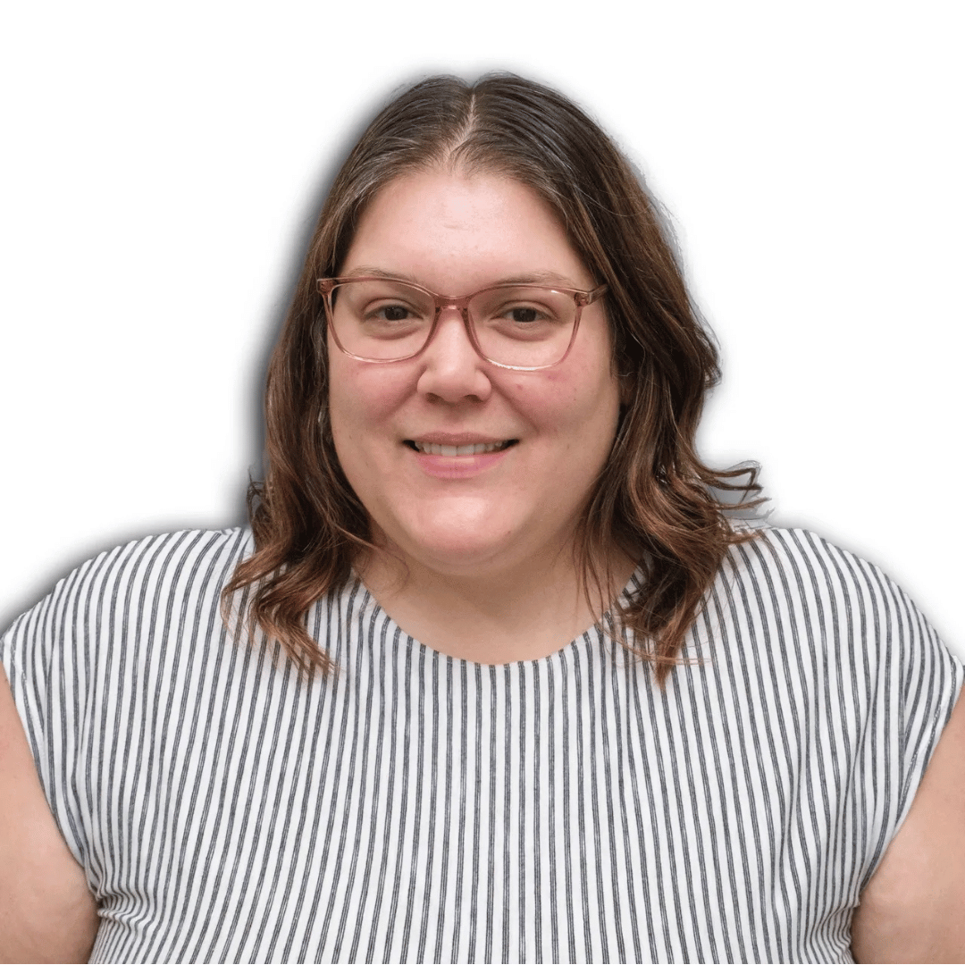 A woman wearing glasses and a striped shirt is smiling.