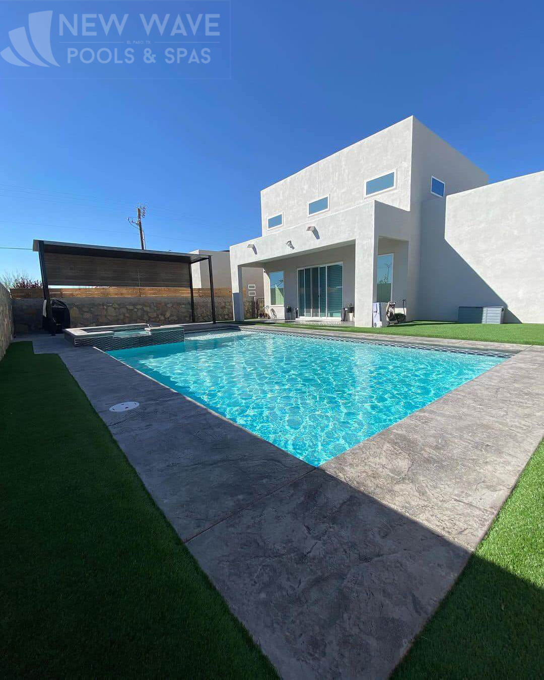 A large white house with a large swimming pool in front of it