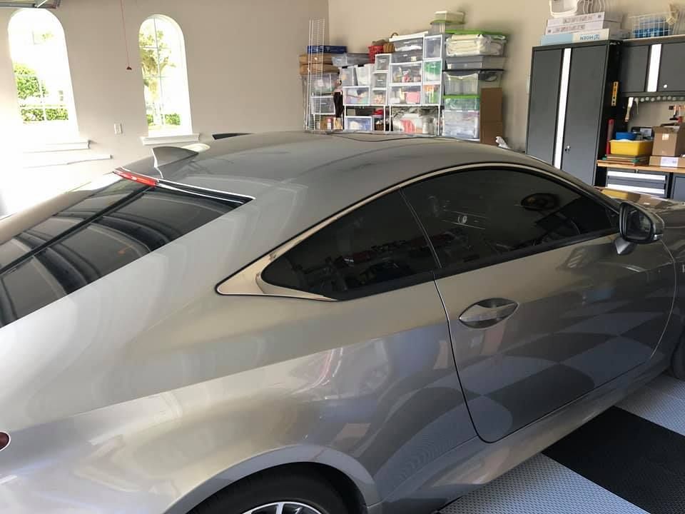 A silver car is parked in a garage.
