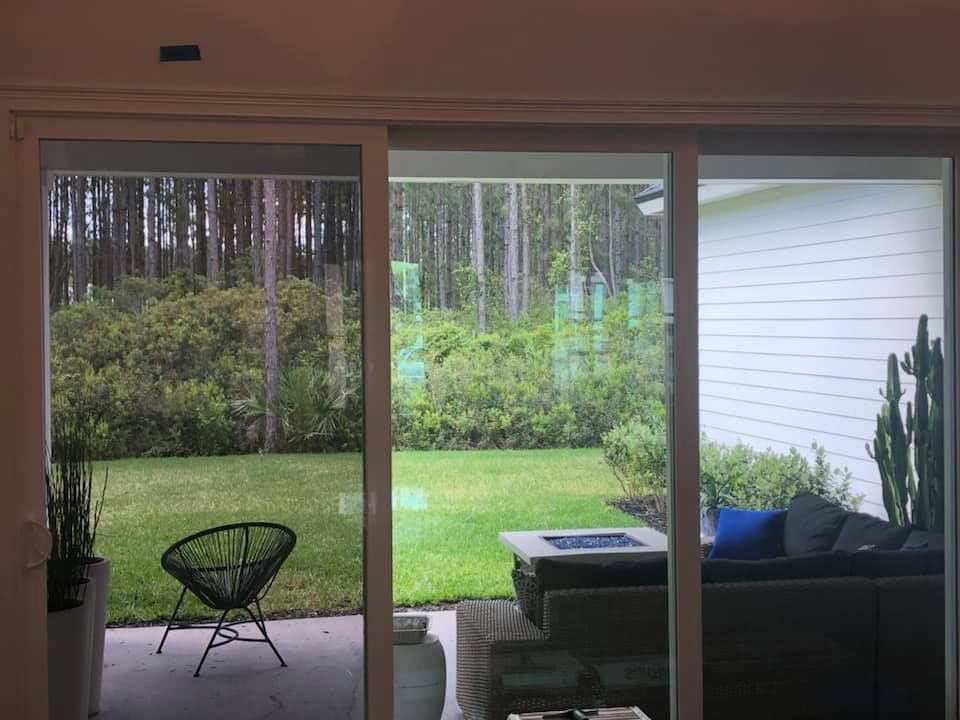 A living room with a sliding glass door leading to a patio.