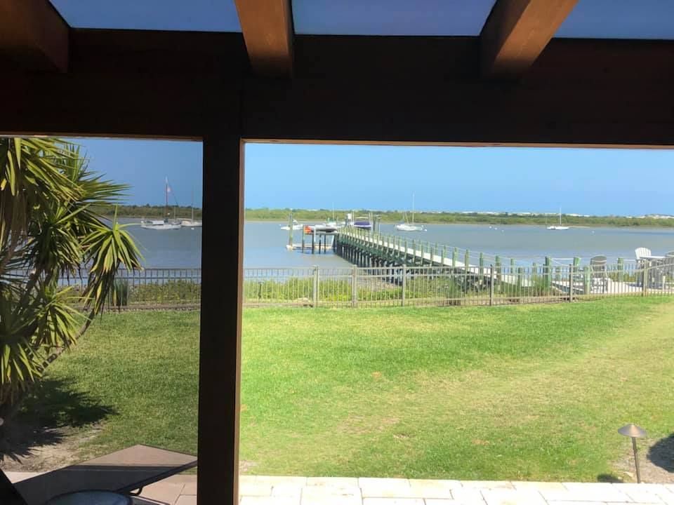 A view of a dock and a body of water from a porch.