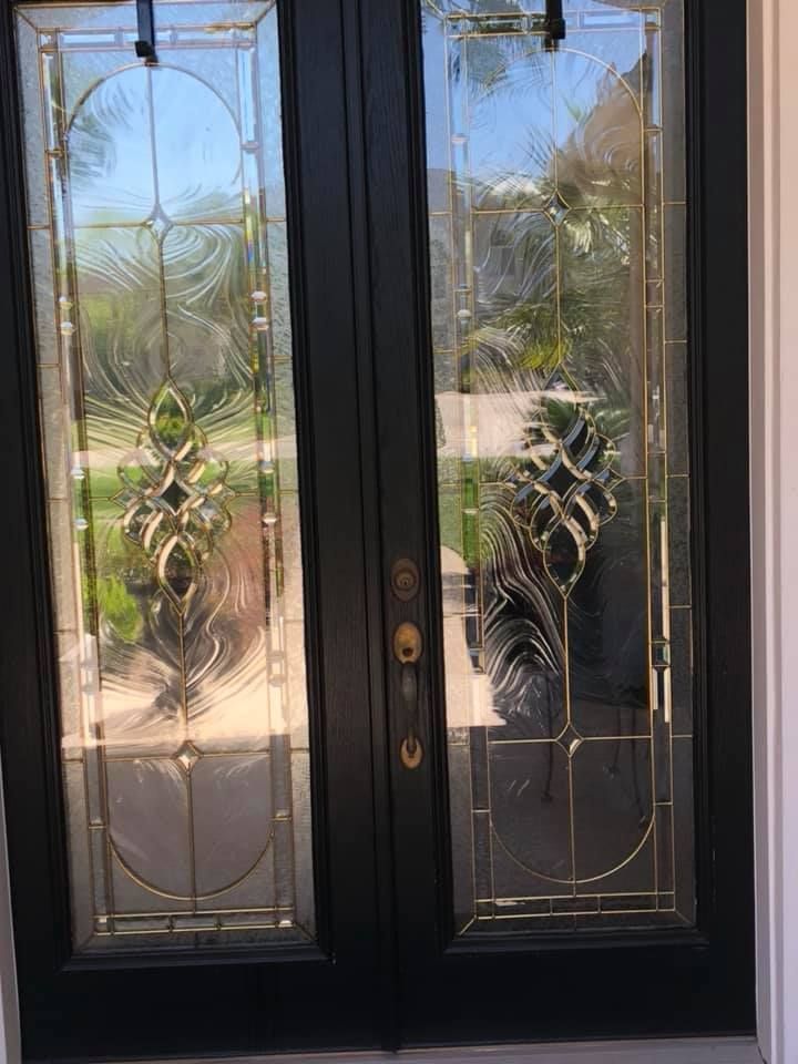 A black door with a stained glass design on it.
