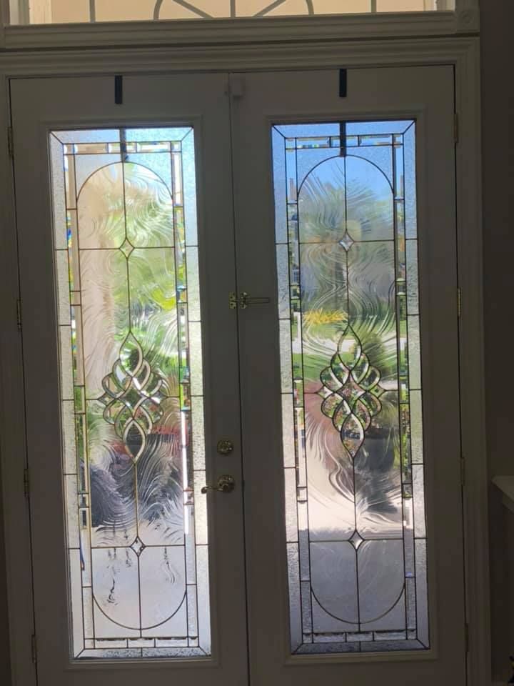 A pair of stained glass doors leading to a patio.