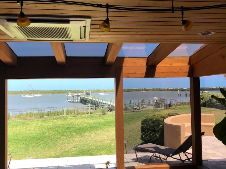 A patio with a view of a body of water
