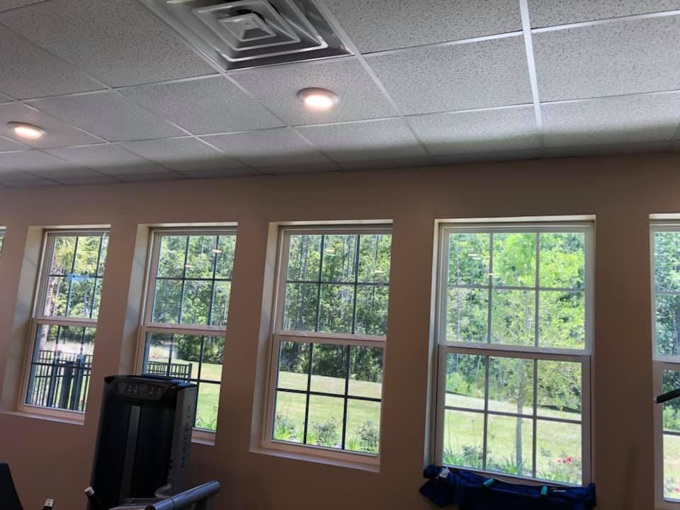 A room with a lot of windows and a treadmill