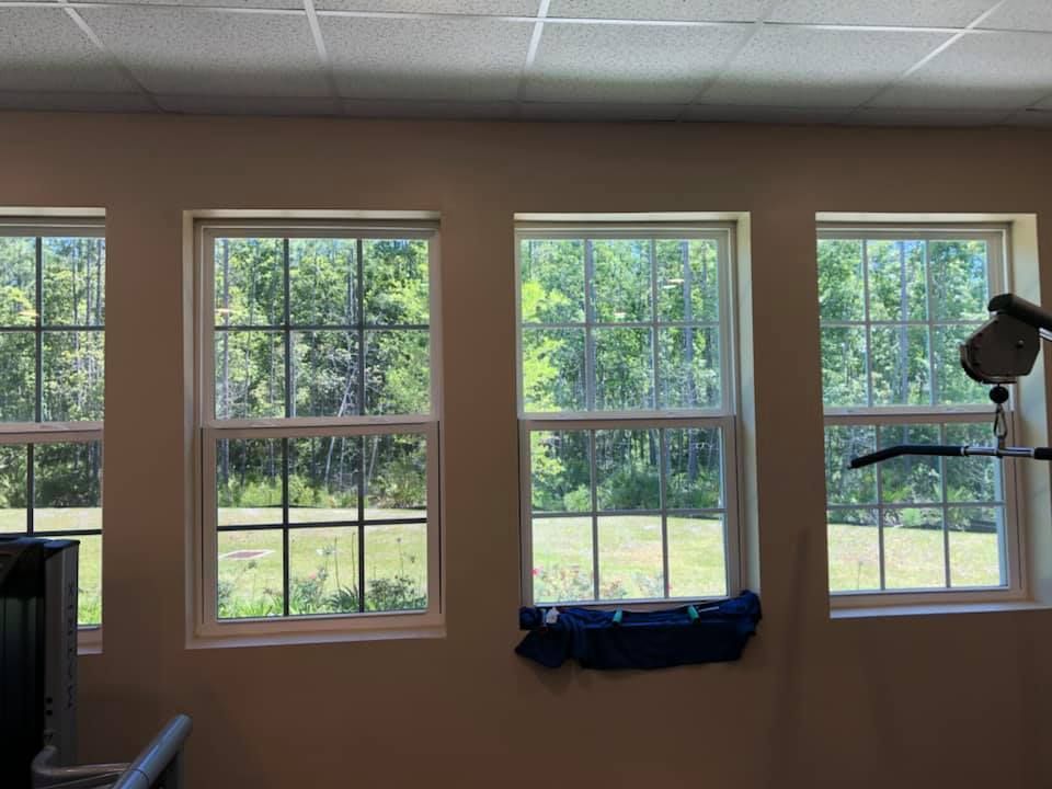 Three windows in a room with a view of trees