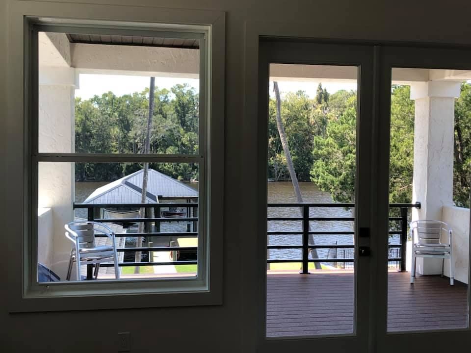 A view of a deck from a window and a door