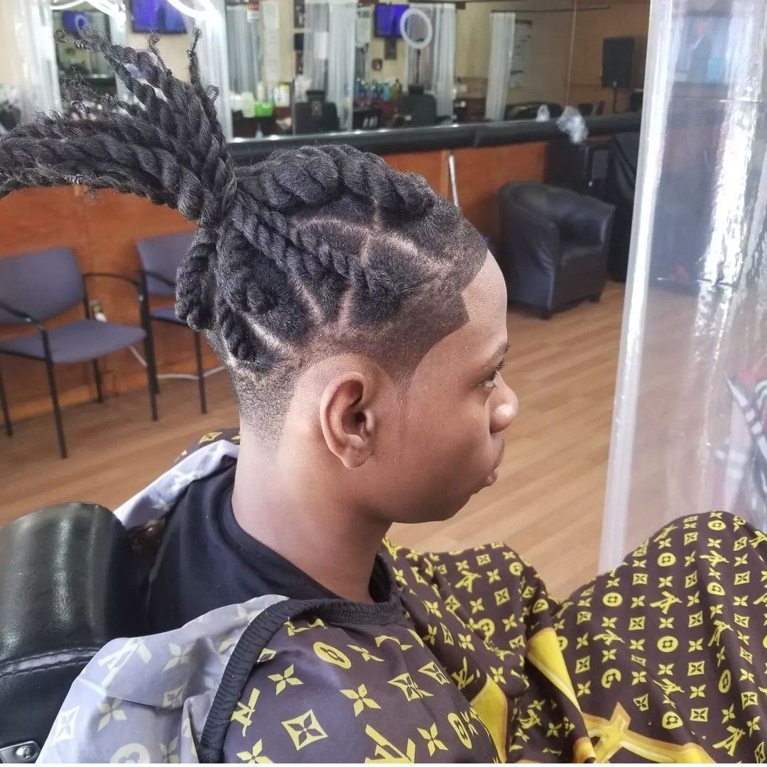 Man with twisted dreadlocks, fade haircut, in a barber shop.