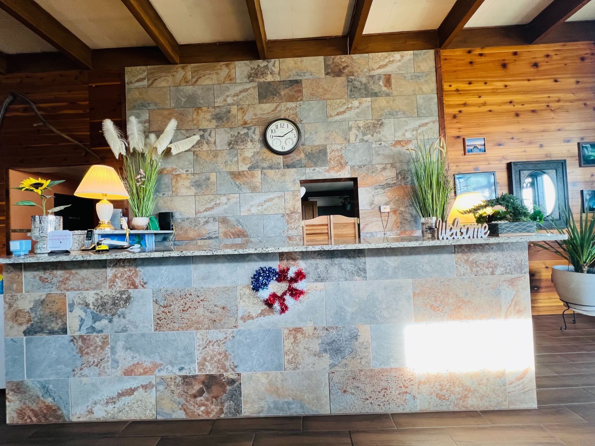 A large stone counter in a room with a clock on the wall.