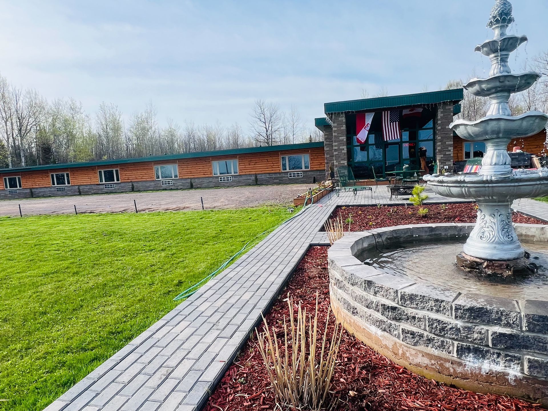 A large house with a fountain in front of it.