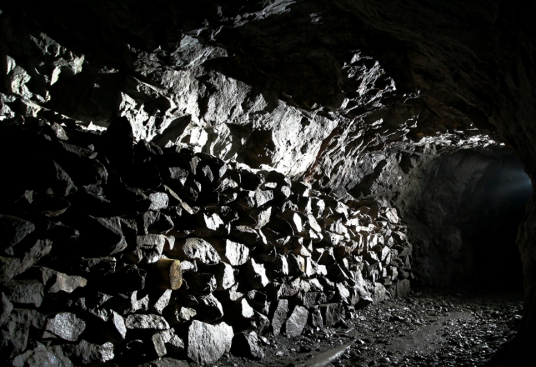 A dark cave with a lot of rocks in it