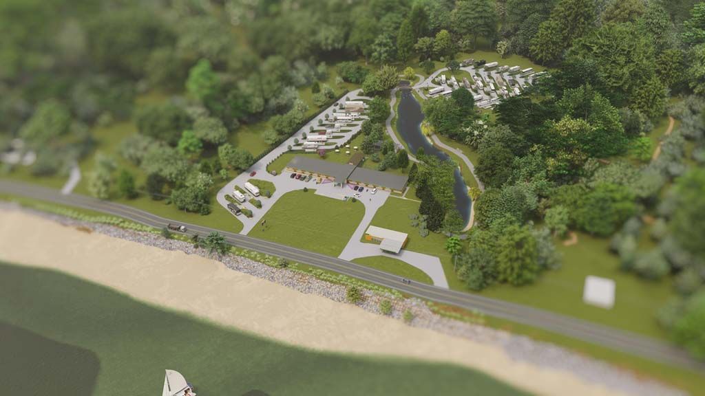 An aerial view of a park with a lot of trees and a road.