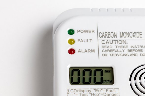Carbon monoxide detector with green power light, yellow fault light, red alarm light, and LCD displaying