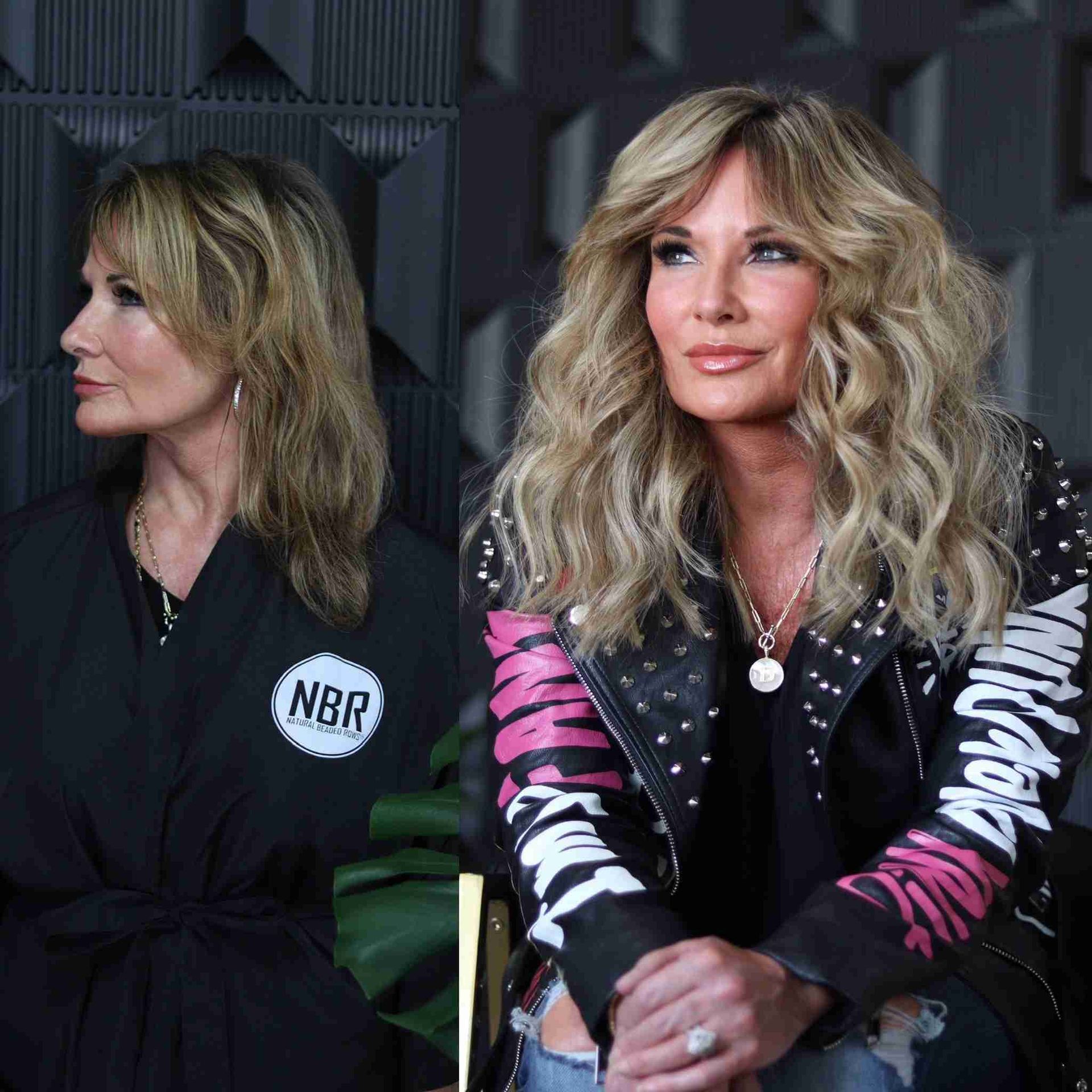 A woman in a black robe and a woman in a leather jacket are sitting next to each other.