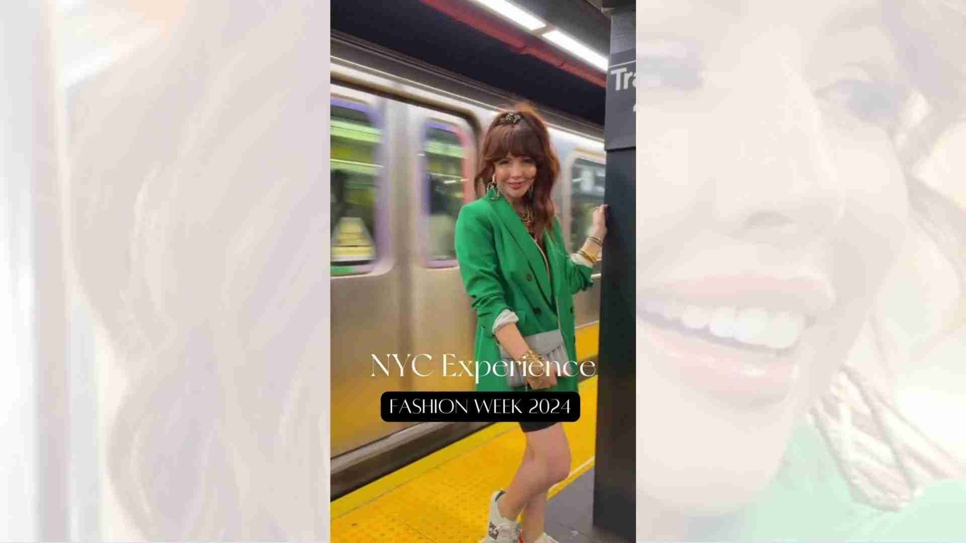 A woman in a green jacket is standing on a train platform.