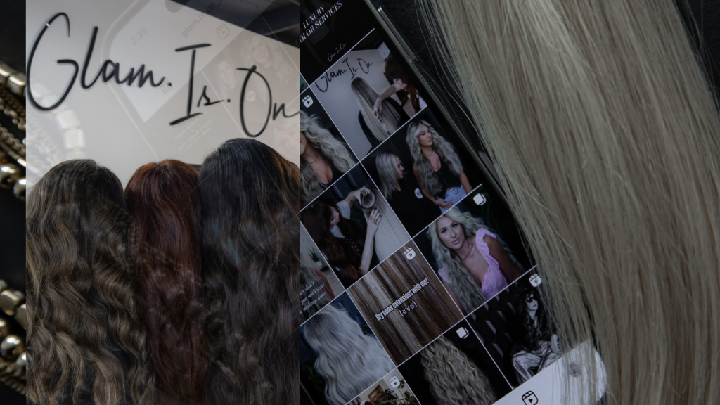 A woman is taking a picture of her hair in front of a mirror.