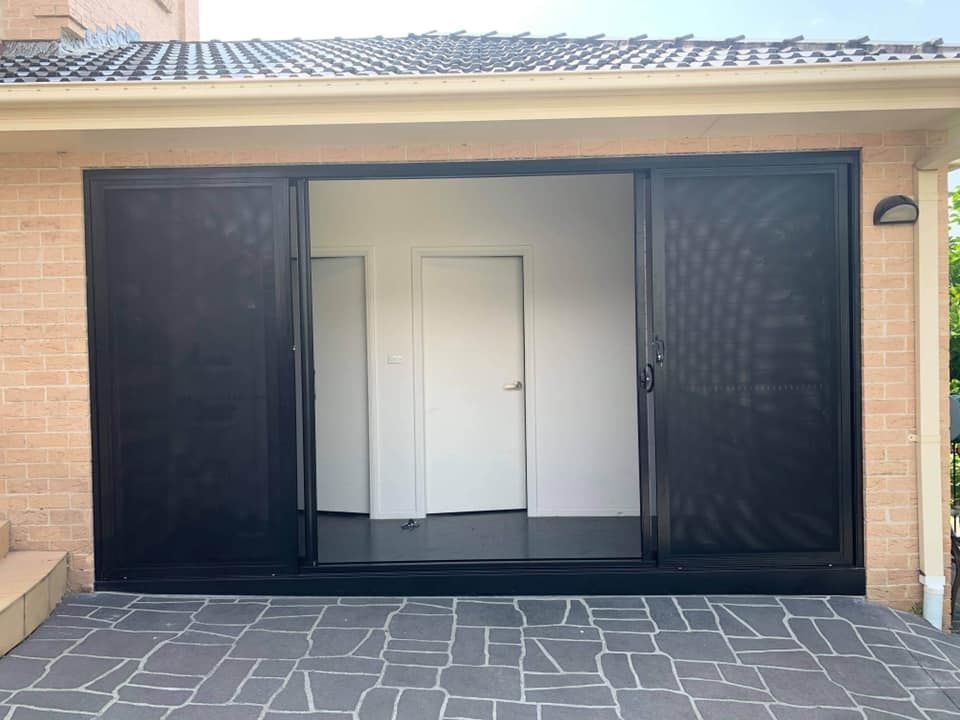 A House with A Sliding Glass Door and A Brick Wall — Distinctive Glass & Aluminium in Port Kembla, NSW