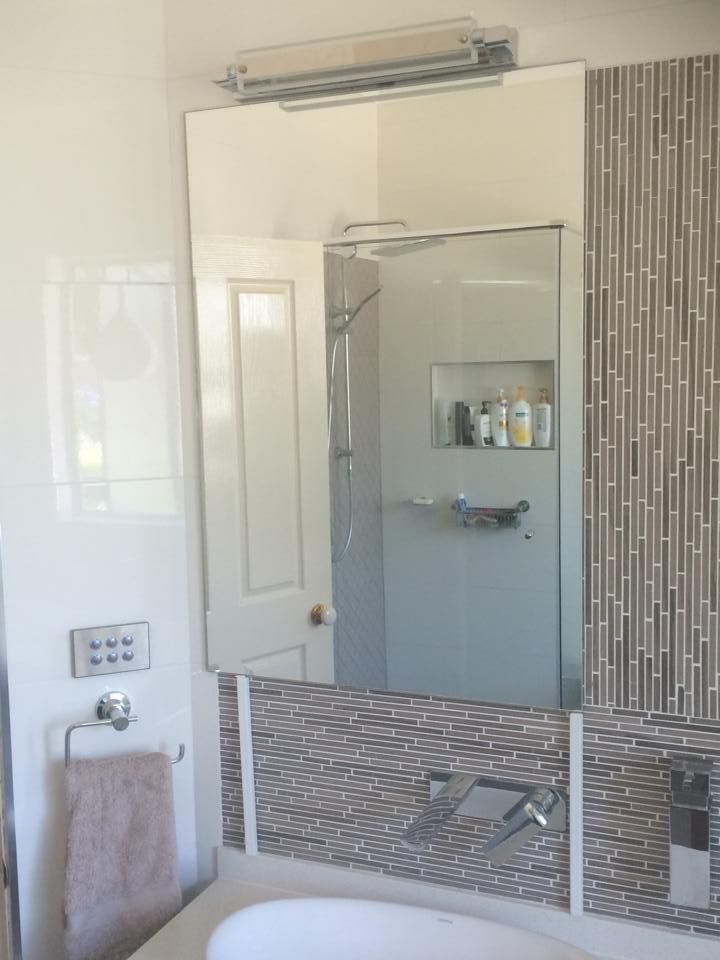 A Bathroom with A Large Mirror and A Bathtub — Distinctive Glass & Aluminium in Albion Park, NSW