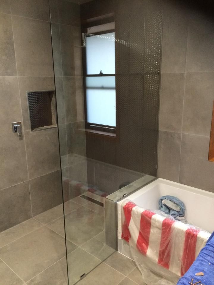 A Bathroom with A Walk in Shower and A Bathtub — Distinctive Glass & Aluminium in Port Kembla, NSW