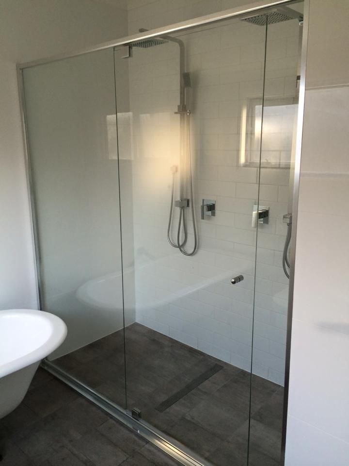 A Bathroom with A Bathtub and A Shower Stall — Distinctive Glass & Aluminium in Thirroul, NSW
