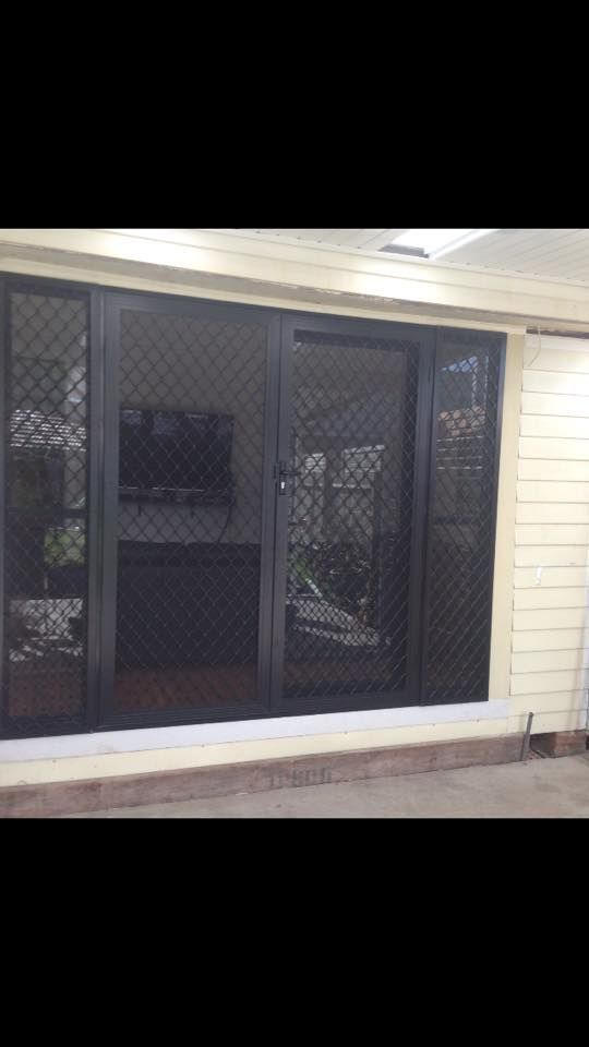 A Living Room with A Sliding Glass Door — Distinctive Glass & Aluminium in Albion Park, NSW