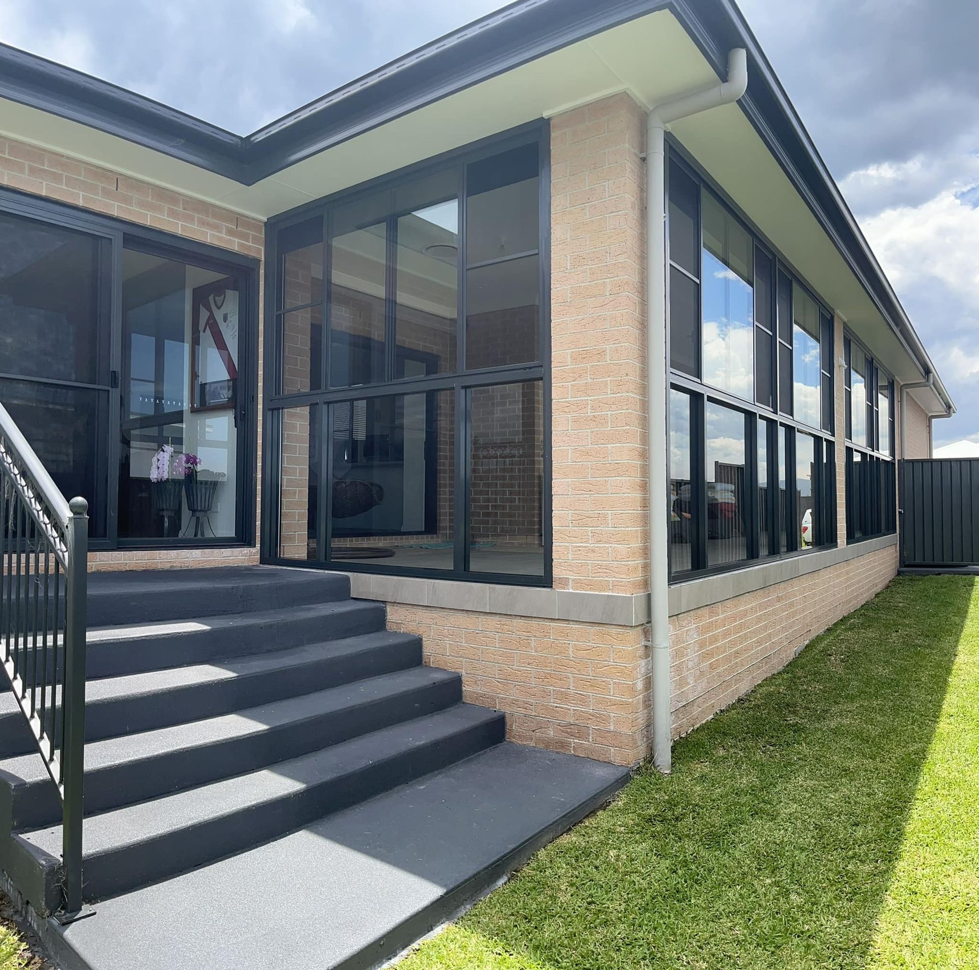 A House with A Sliding Glass Door and A Cat Door — Distinctive Glass & Aluminium in Port Kembla, NSW