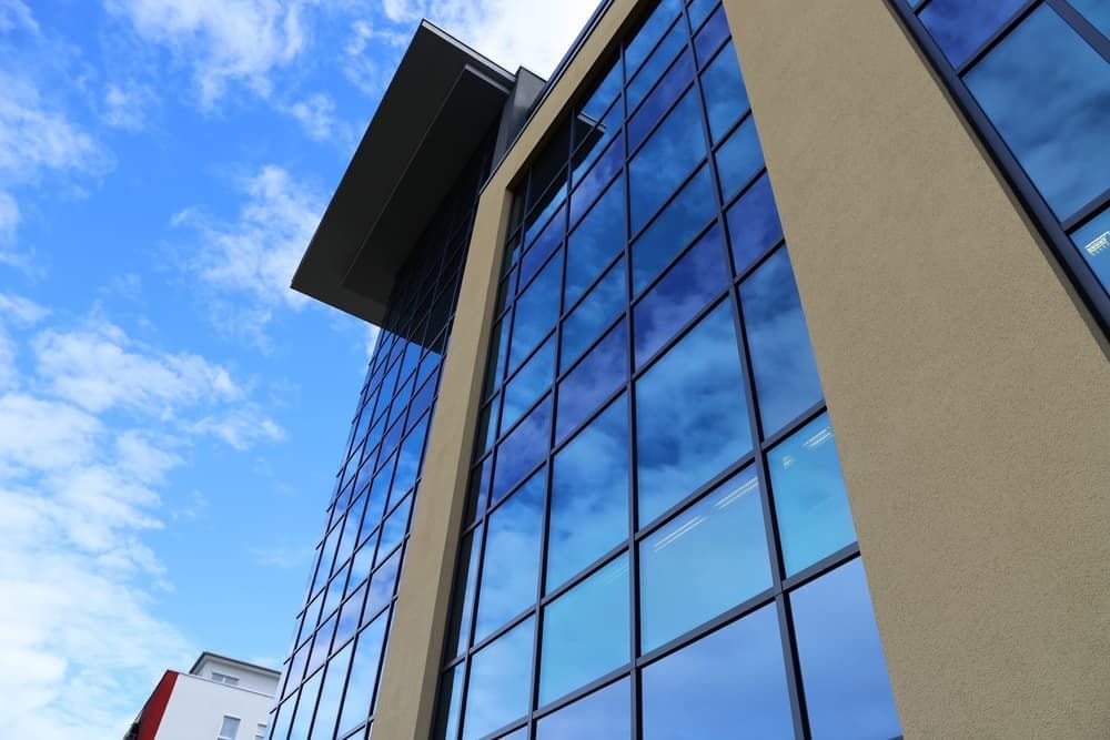 Looking up At a Tall Building with Lots of Windows — Distinctive Glass & Aluminium in Kiama, NSW