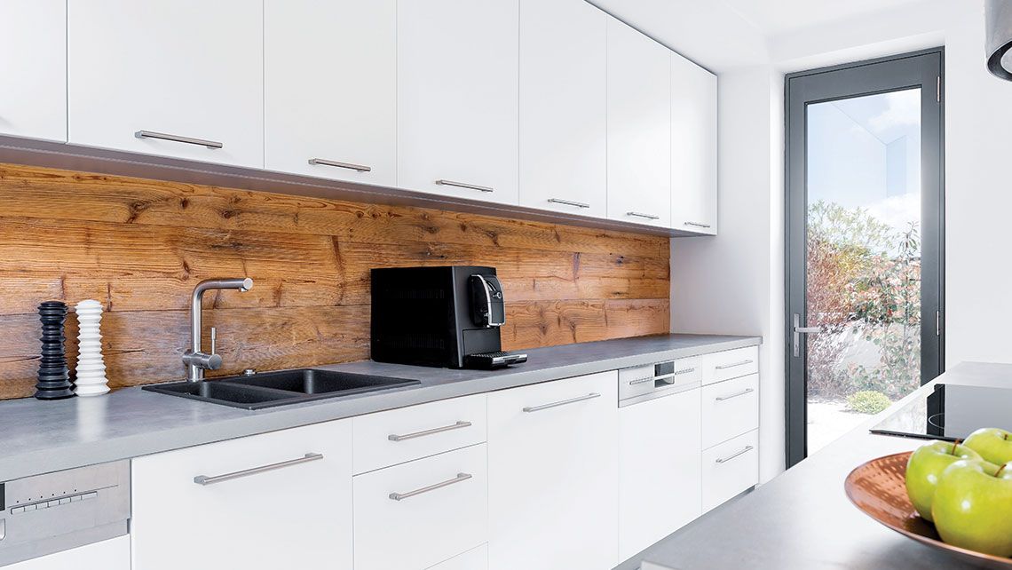 A Kitchen with White Cabinets and A Bowl of Apples — Distinctive Glass & Aluminium in Port Kembla, NSW