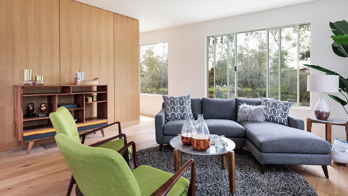 A Living Room with A Couch, Tables and A Rug — Distinctive Glass & Aluminium in Port Kembla, NSW