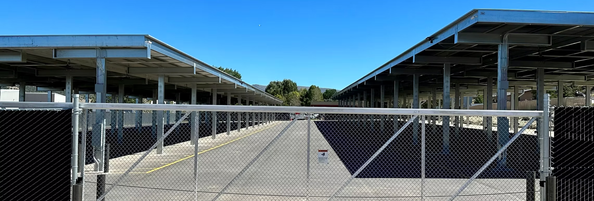 Secured entrance with gated fencing at Eagle Canopy RV Storage facility