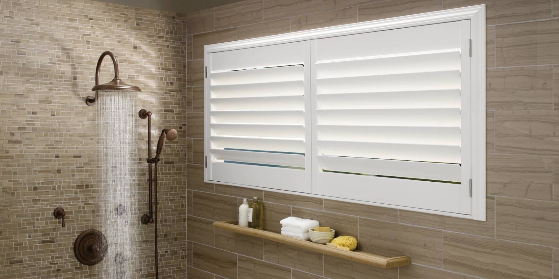 Durable yet stylish Hunter Douglas Palm Beach™ Polysatin™ Vinyl Shutters inside a walk-in shower nea