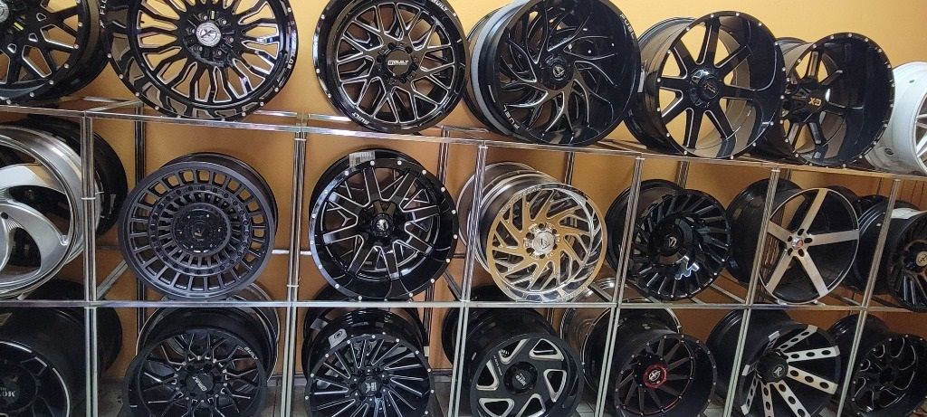 There are many different types of wheels on display in this store.