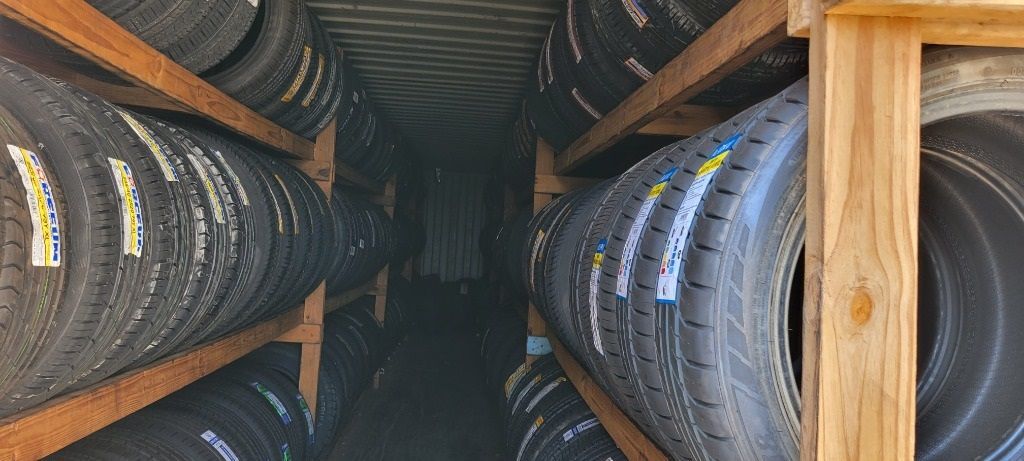 A warehouse filled with lots of tires on wooden shelves.