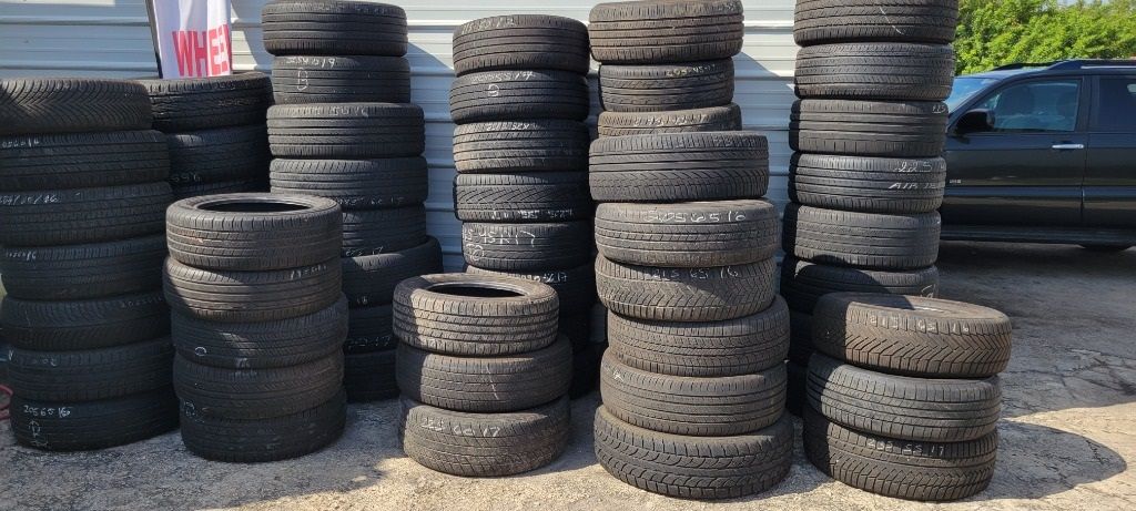A bunch of tires are stacked on top of each other.