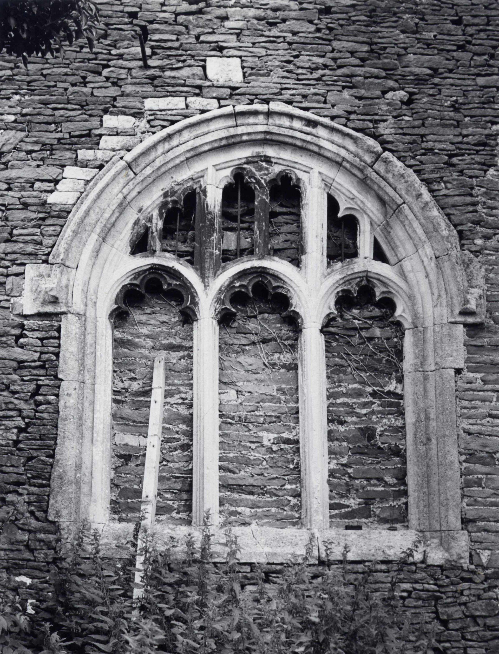 A black and white photo of a window at Acton Court