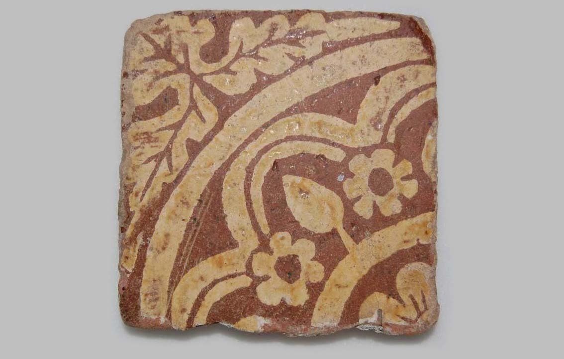 Tudor square tile with a floral pattern on it.