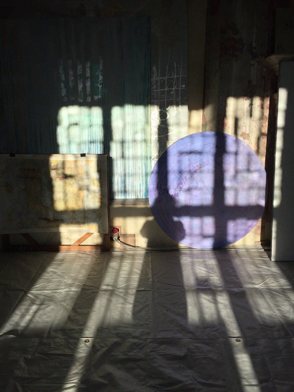 The sun is shining through the window and casting a shadow on the floor.