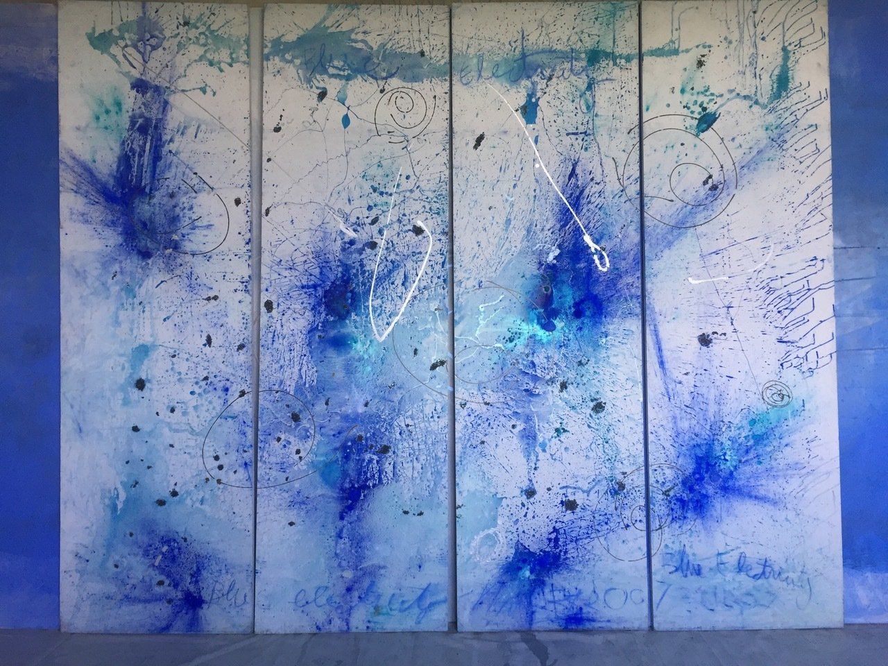 A blue and white painting on a blue wall