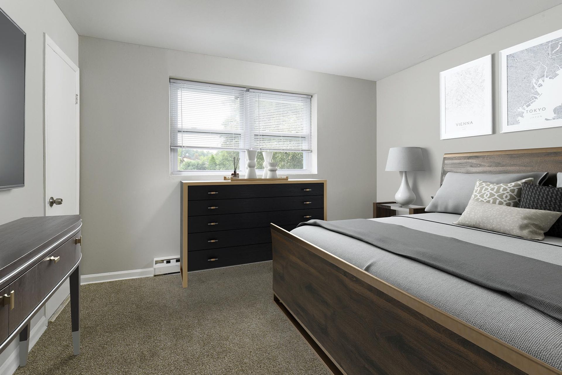 Bedroom in an apartment with a wooden bed frame, dresser, nightstand, and window blinds.