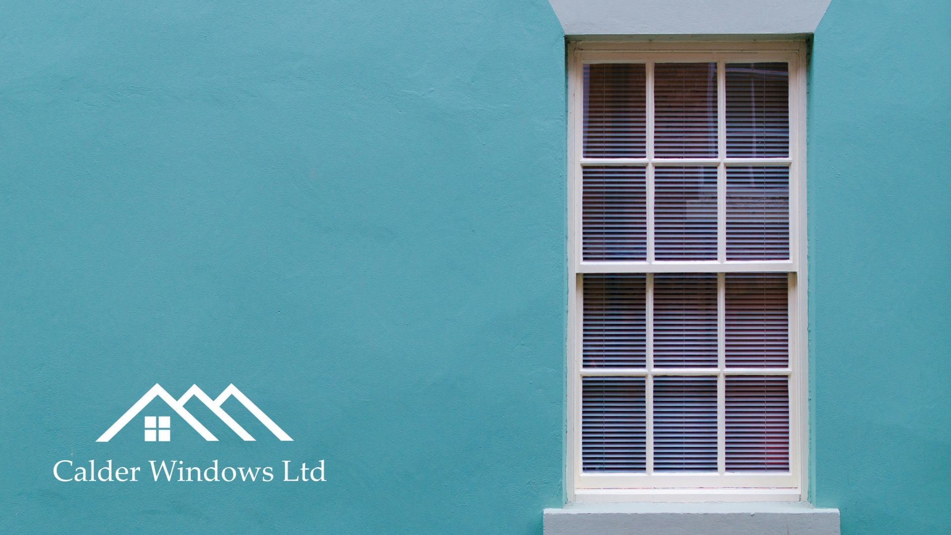 Teal building wall with a white-framed window and Calde Windows Ltd logo