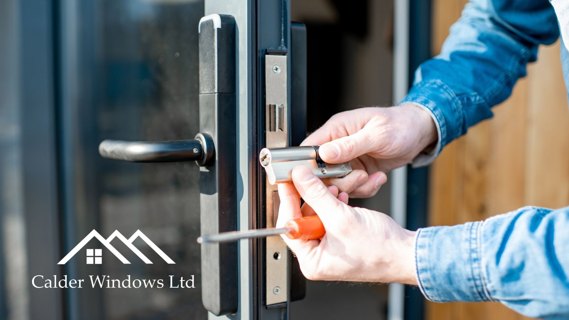Hands unlocking a glass door with a key in the lock