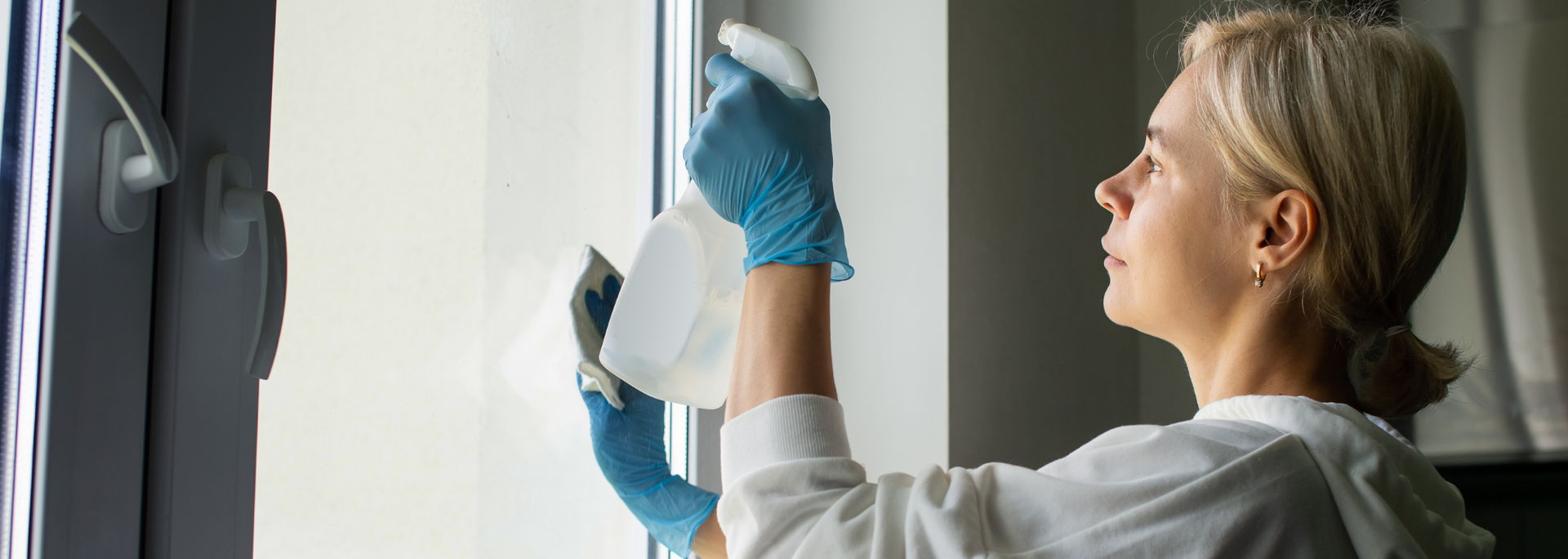 Picture of someone cleaning a window. 