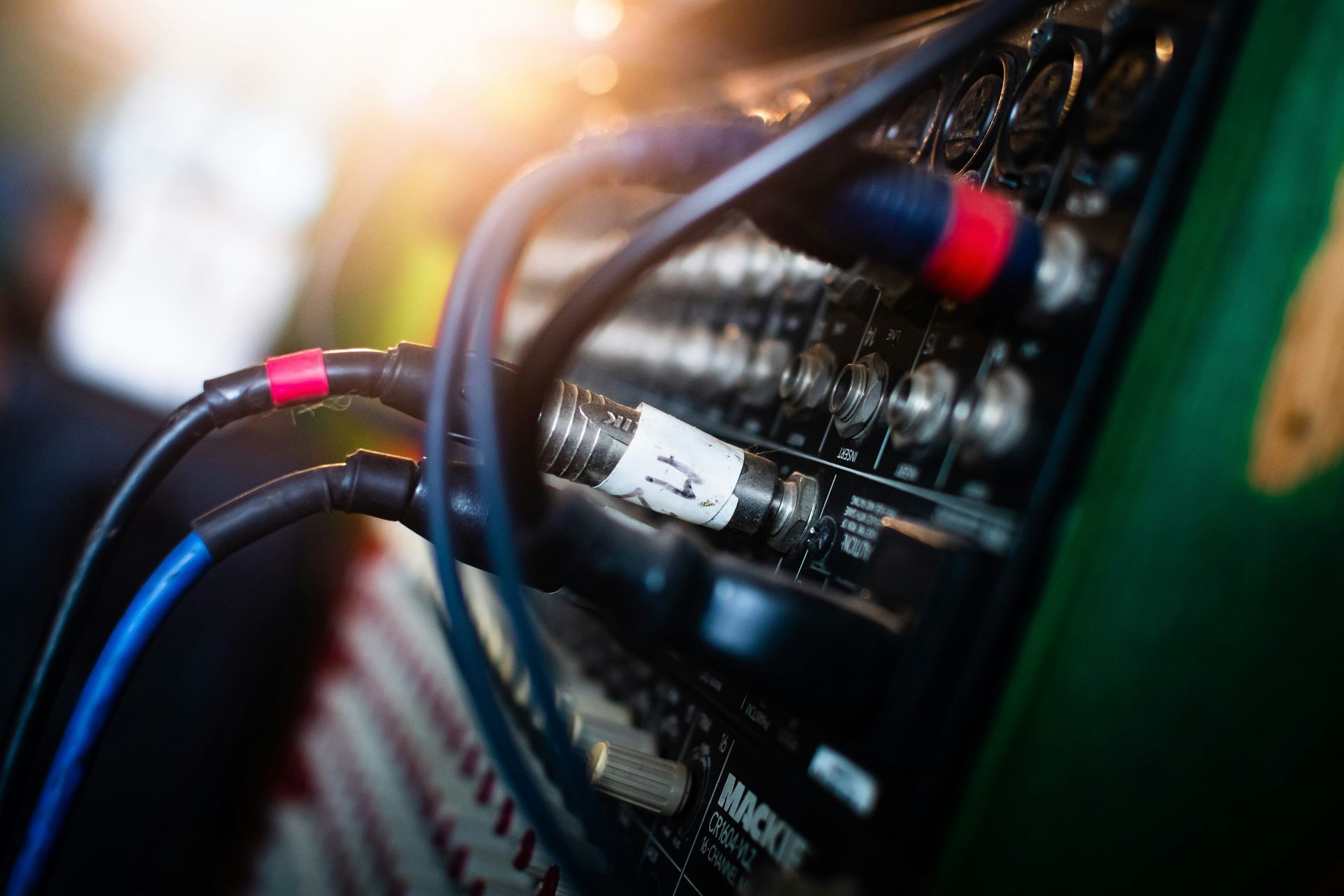 A close up of a mixer with cables plugged into it.