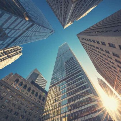 The sun is shining through the windows of a city skyscraper.