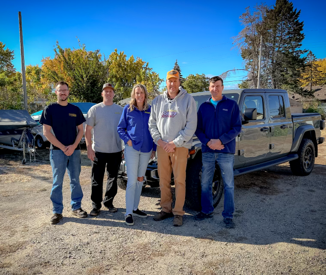 A group of people standing in front of a truck. | Wagamon Brothers