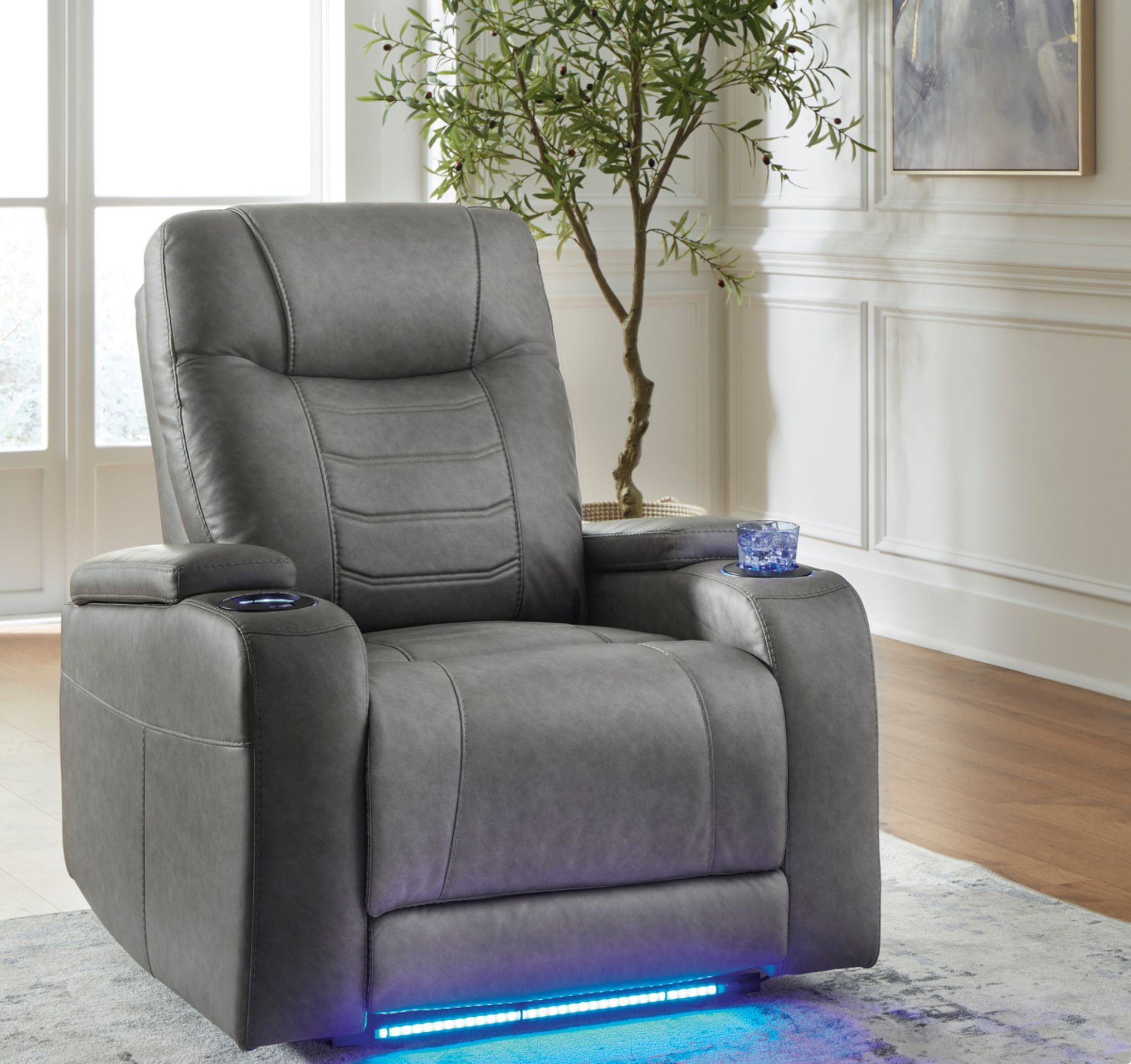 Gray recliner chair with cup holders and blue LED lighting.