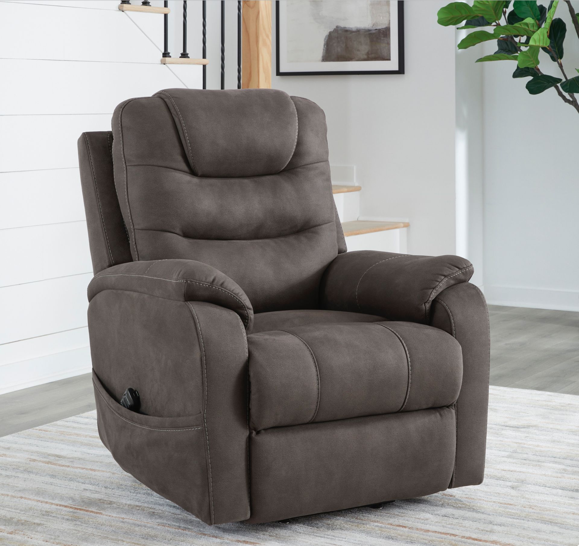 Brown recliner chair on a light rug, in a neutral-toned room.