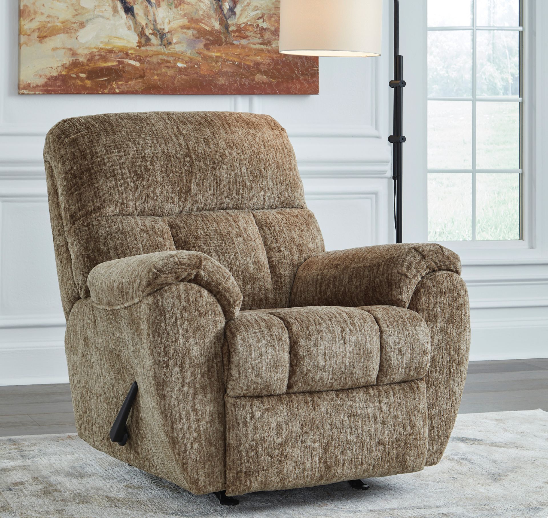 Brown recliner chair with textured upholstery, set in a room with a painting and lamp.