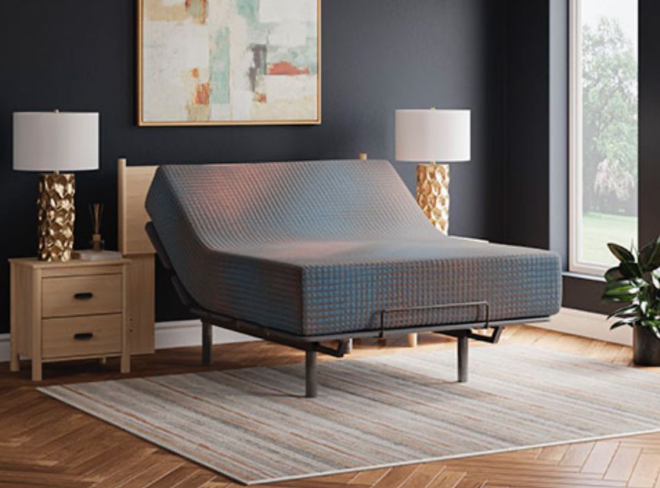 Adjustable bed with patterned mattress in a bedroom setting.