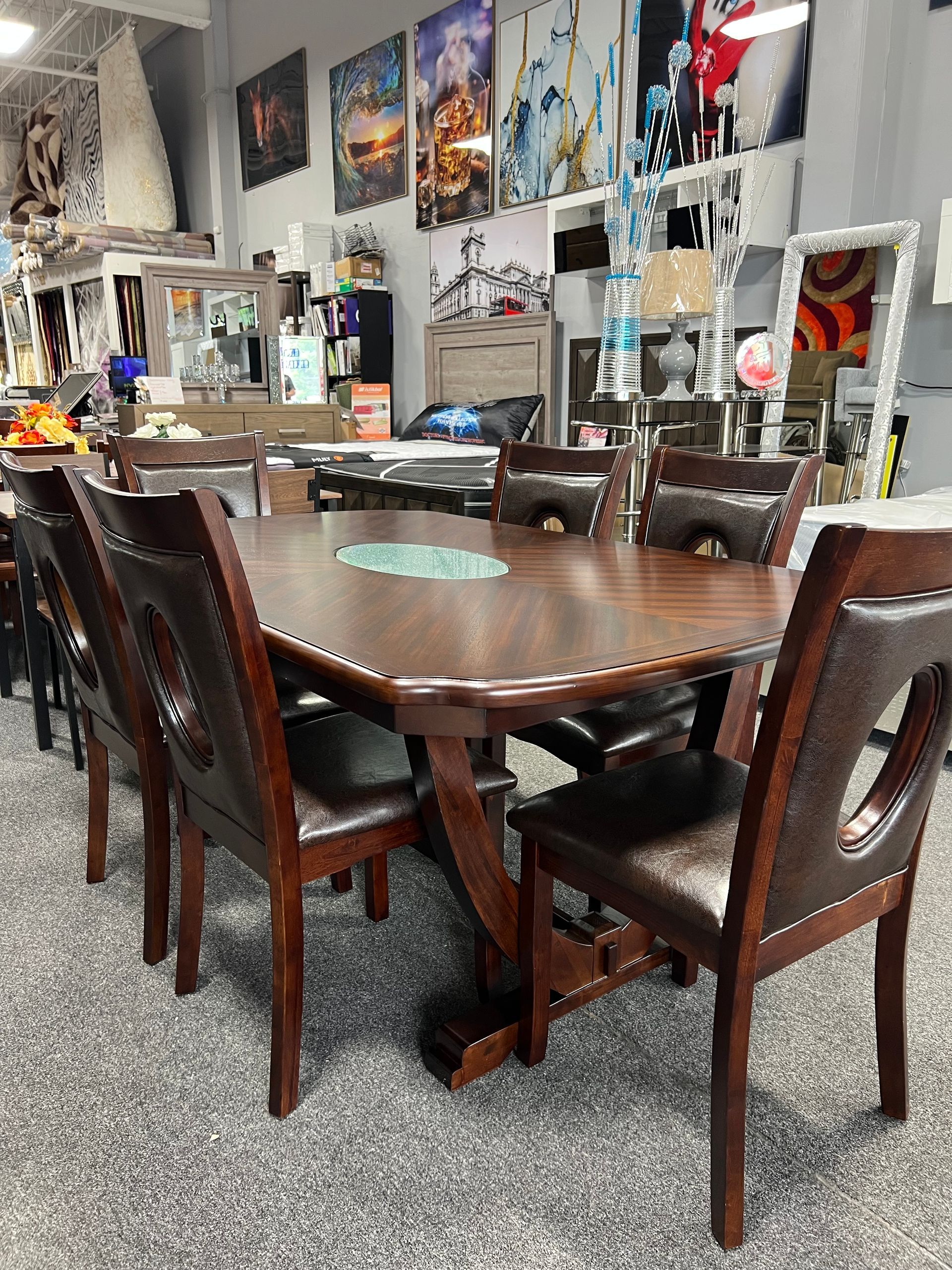 Furniture showroom with tables, seating, and decorative mirrors.